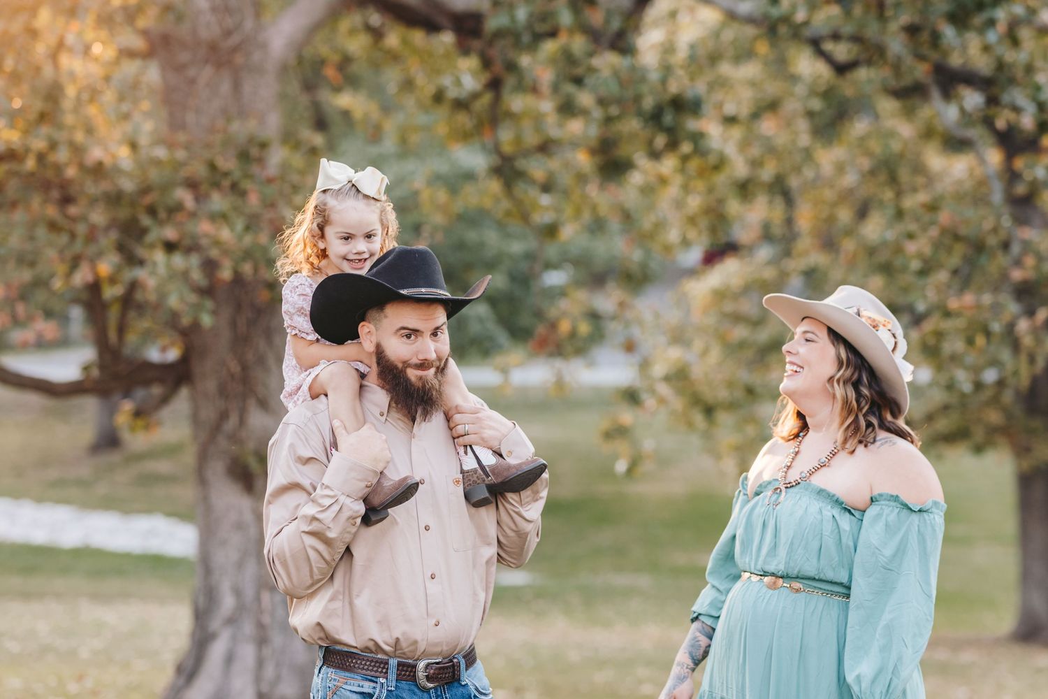 A playful moment shared between family members in a scenic park during autumn.