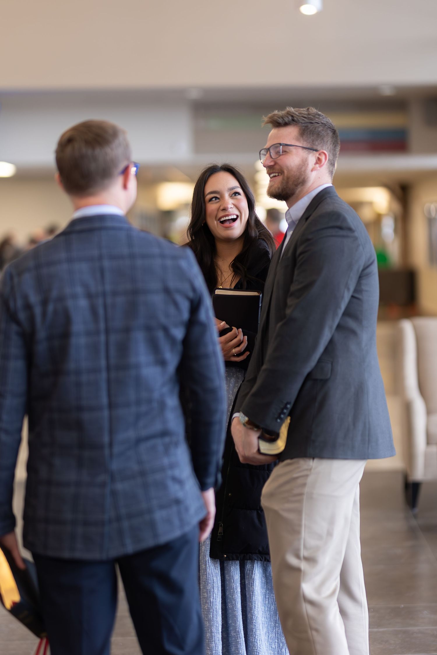 Group of people having an animated discussion in modern building interior.
