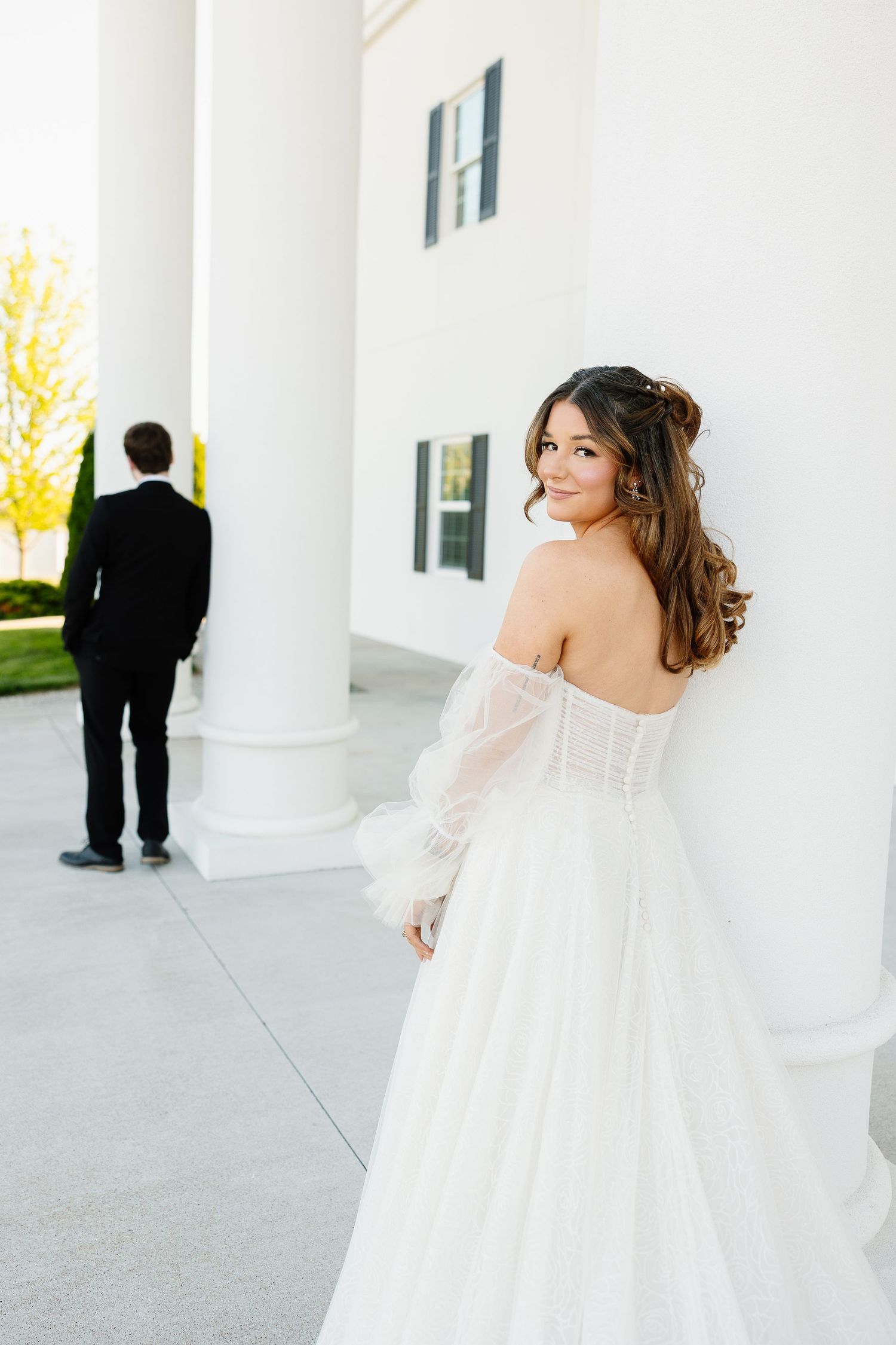 Elegant outdoor wedding photoshoot series featuring white columns and a bride in an off-shoulder gown with flowing details.