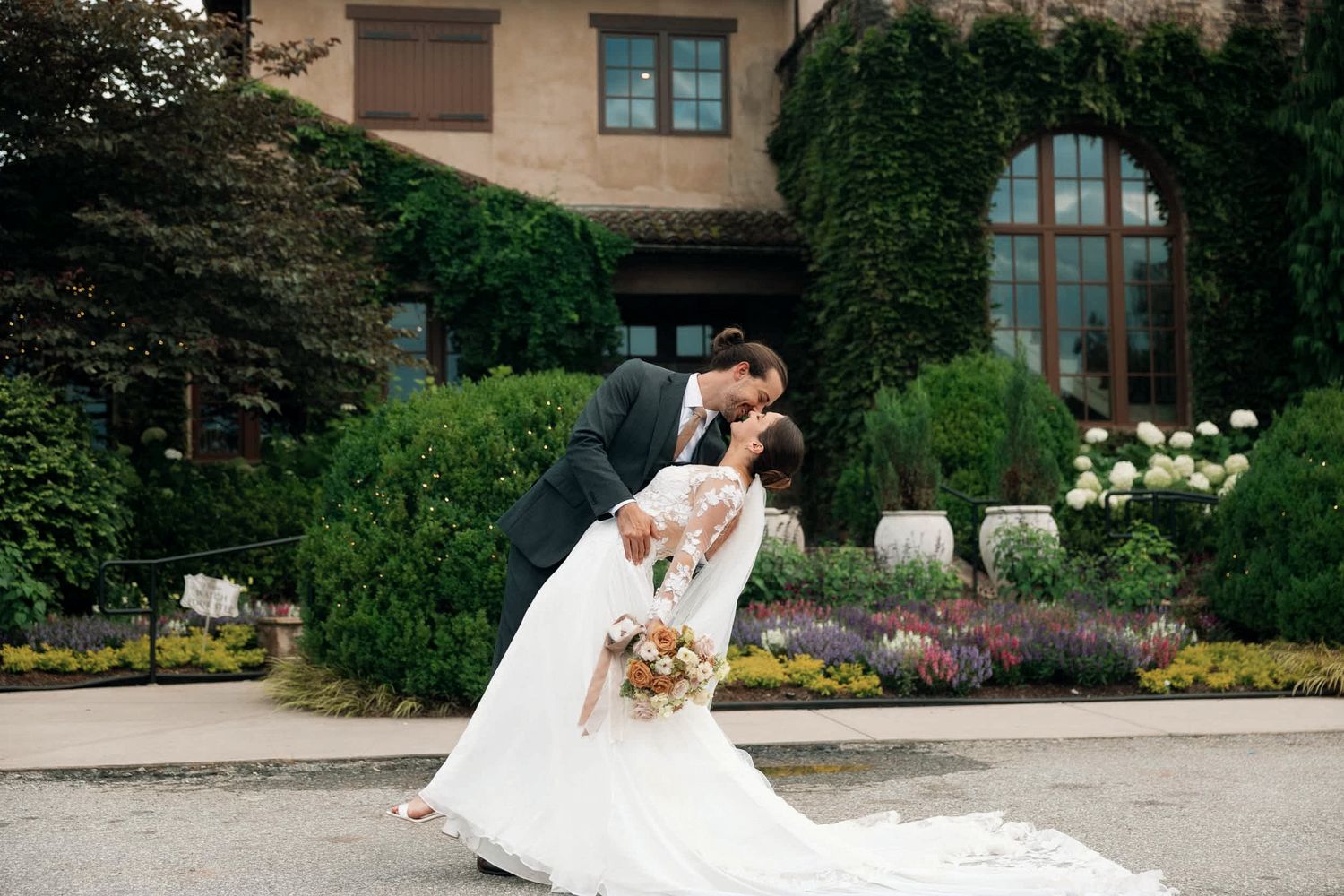 Bride and groom share a romantic dip kiss in front of Montaluce Winery & restaurant in Dahlonega, georgia