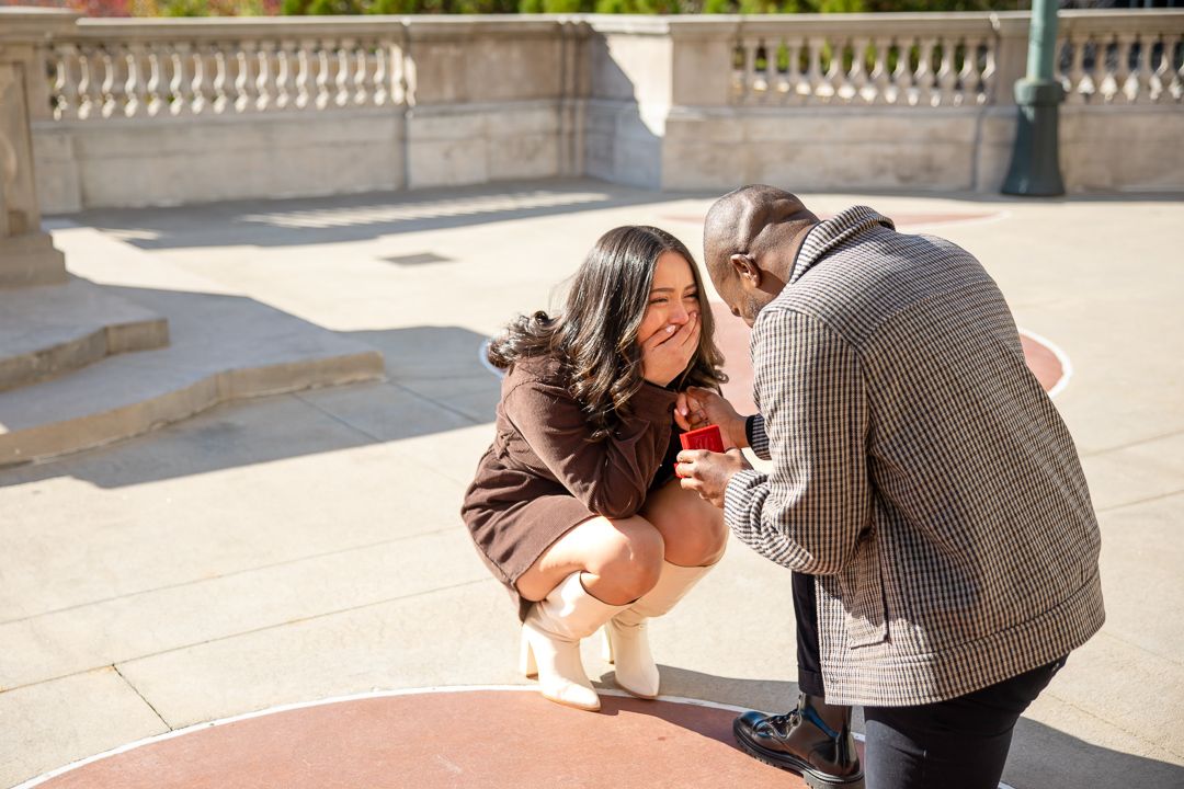 candid moments at an engagement session at Millennium Gate Museum