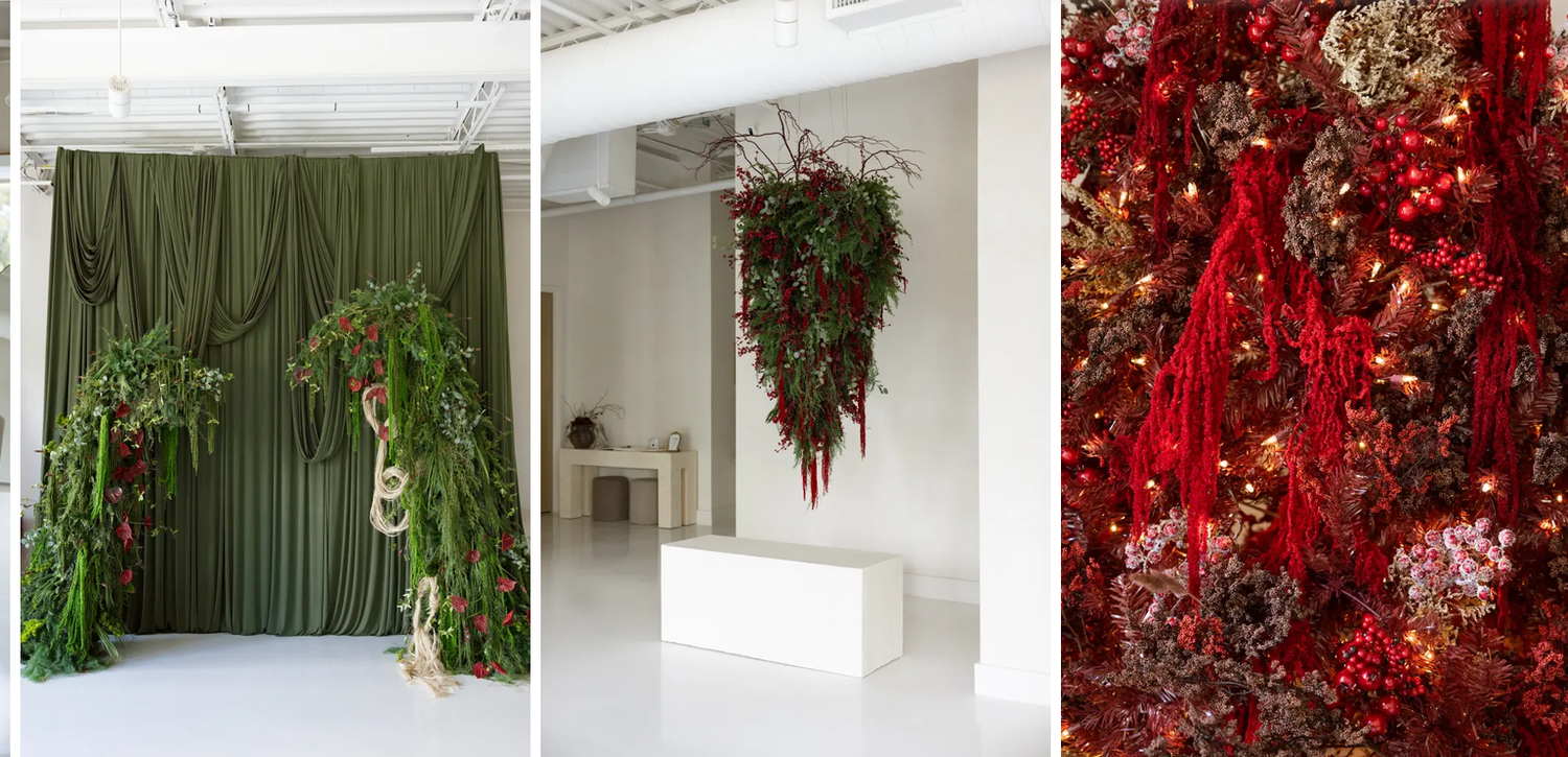 Lush green floral installations hang in a white studio space alongside a vibrant red botanical arrangement with cascading ribbons.