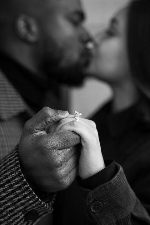 A recently engaged couple sharing an intimate moment at the Millennium Gate Museum in Atlanta