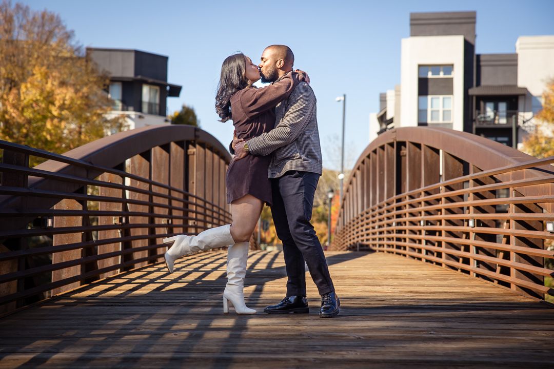 Romantic couple kisses at Millennium Gate during their engagement