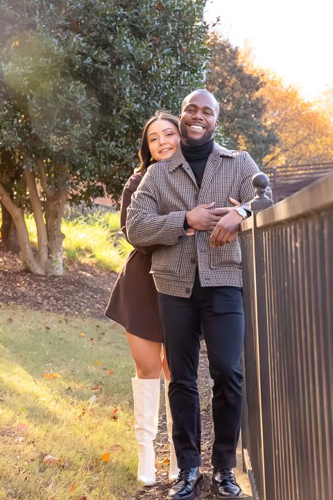 a couple embraces at the Millennium Gate Museum during their engagement photoshoot