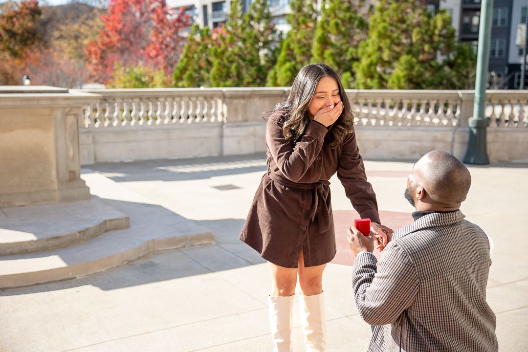 candid moments at a surprise engagement at Millennium Gate Museum