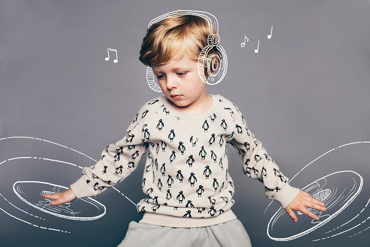 Young child in patterned sweater wearing headphones with illustrated musical notes and waves in a creative composition.