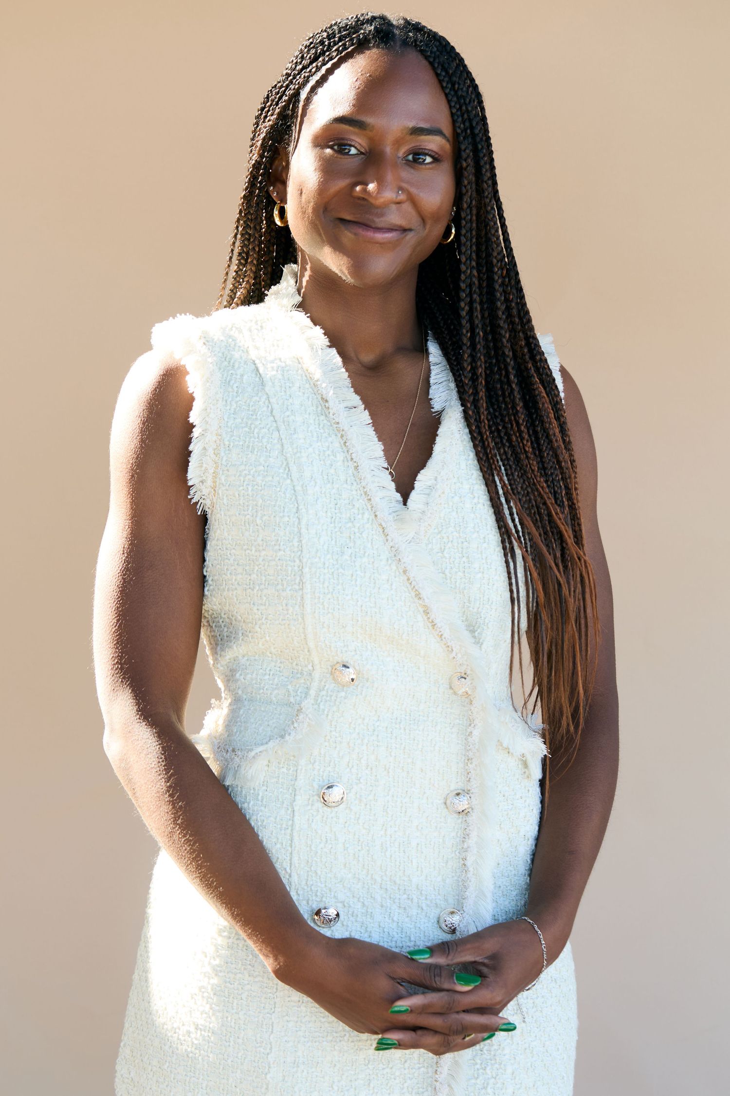 A person wearing a white sleeveless textured top poses in a series of photos against a neutral background.