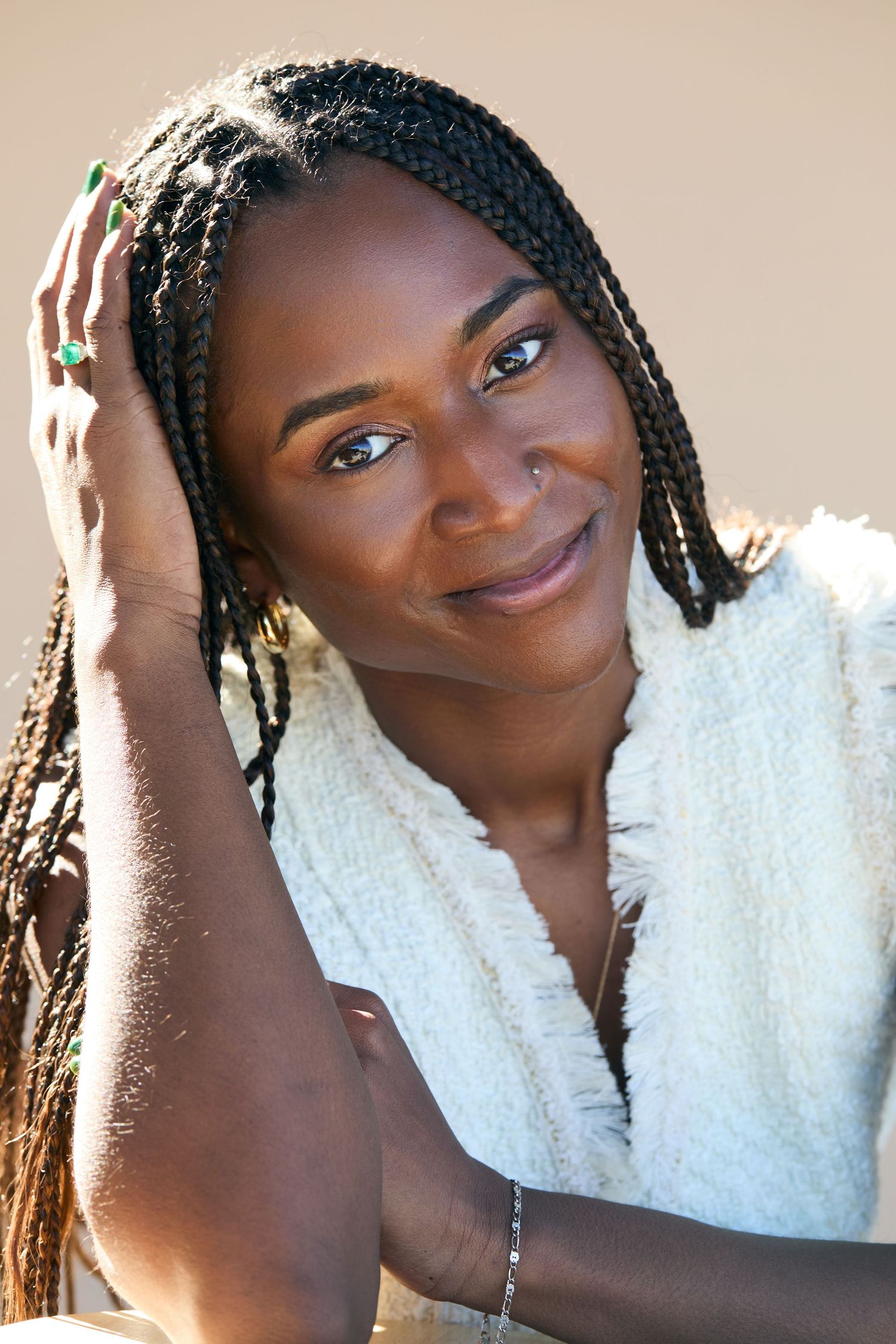 Portrait series showing warm expressions and braided hair against a light background in natural lighting.