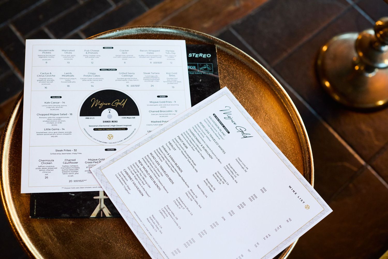 Restaurant menus and papers displayed on a wooden table surface.