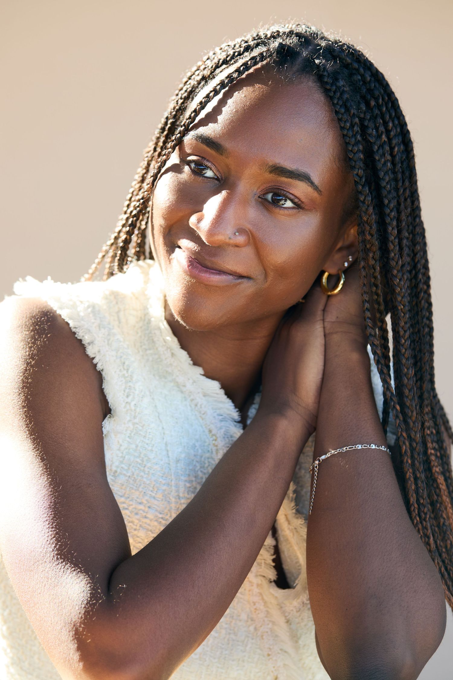 A series of four artistic portrait photos showing joyful expressions and box braids hairstyle against a warm neutral background.