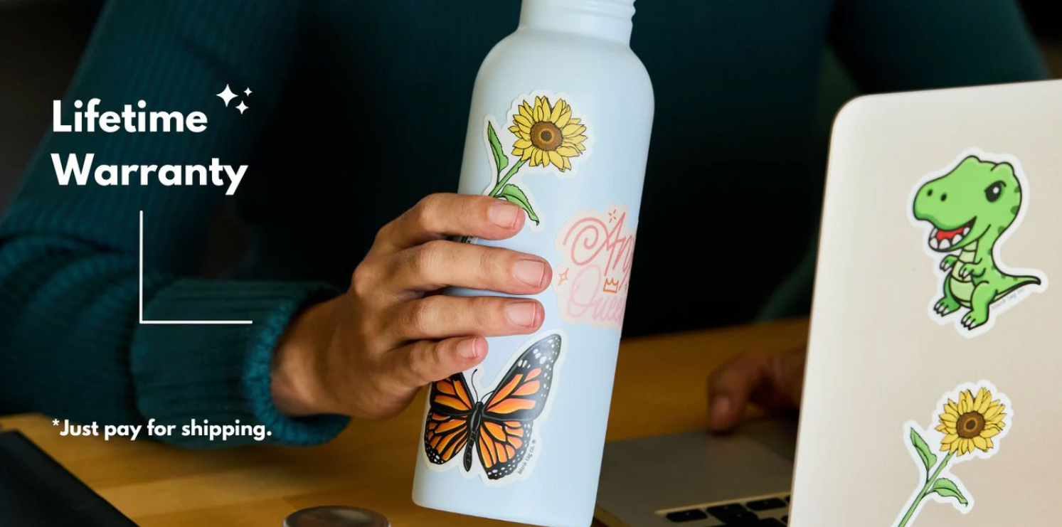 White water bottle with decorative butterfly and sunflower stickers displayed against dark background.