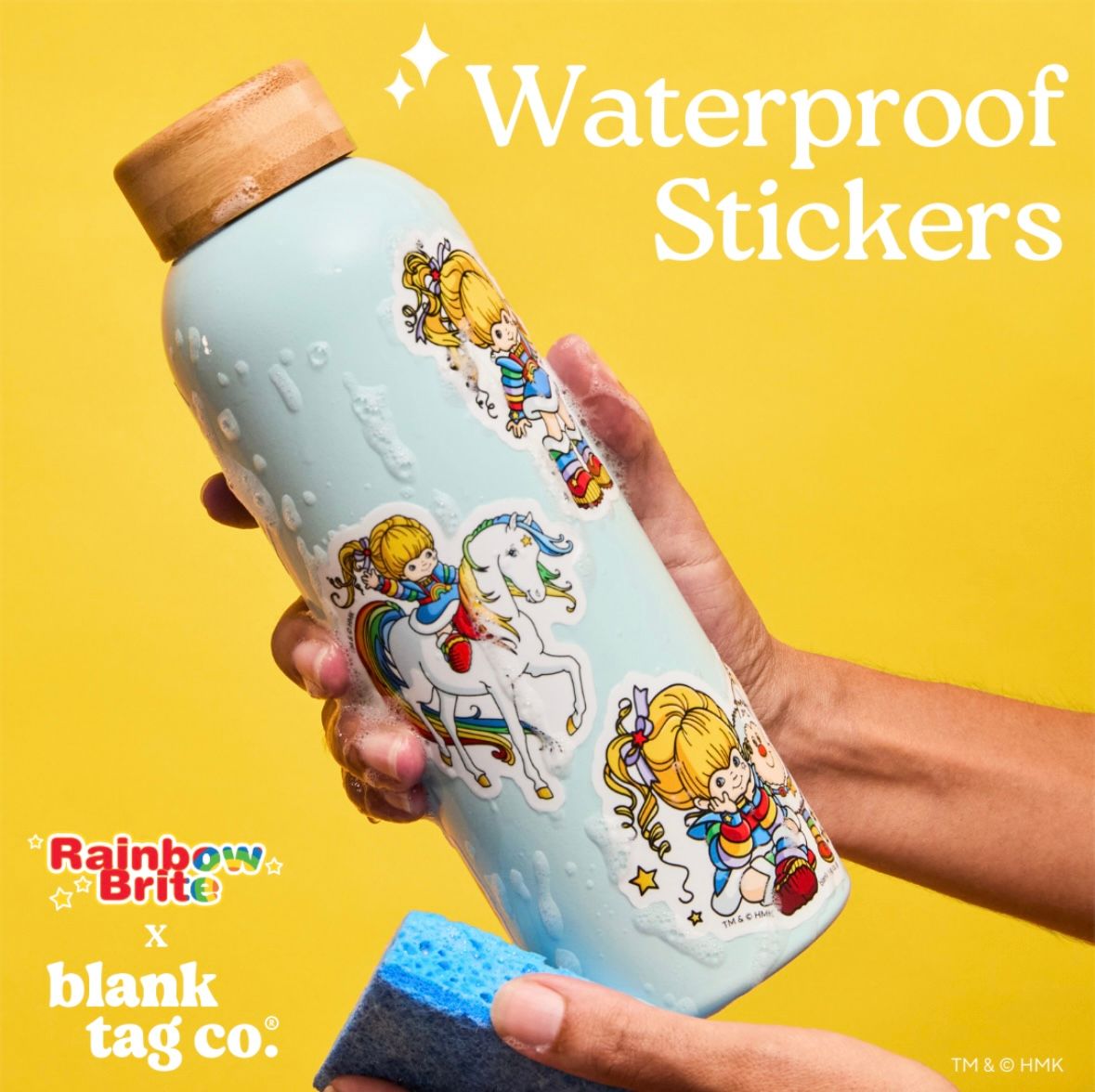 Hand holding a white water bottle decorated with cute cartoon character stickers against a bright yellow background.
