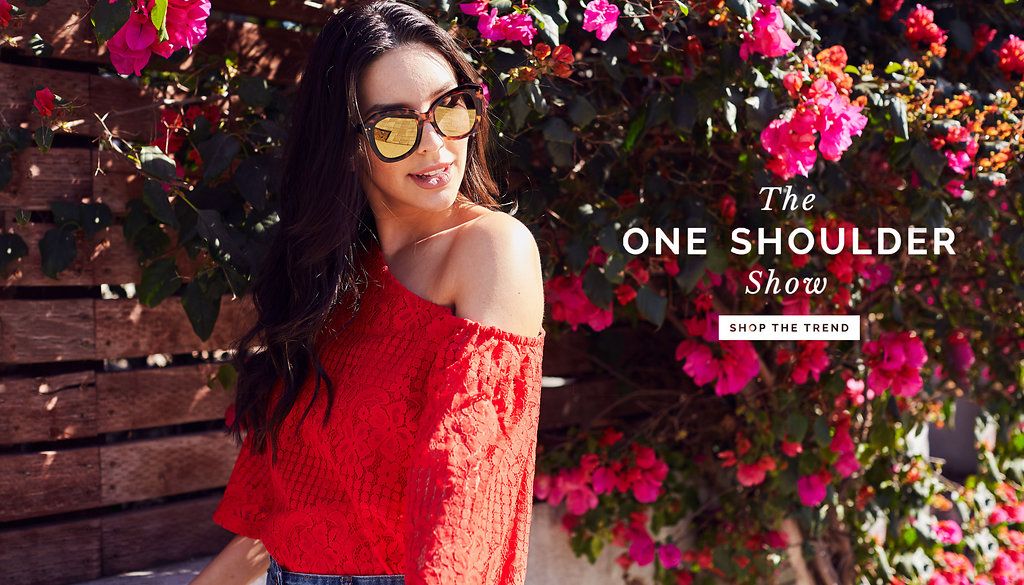 Woman in red lace top against floral background for fashion advertisement.