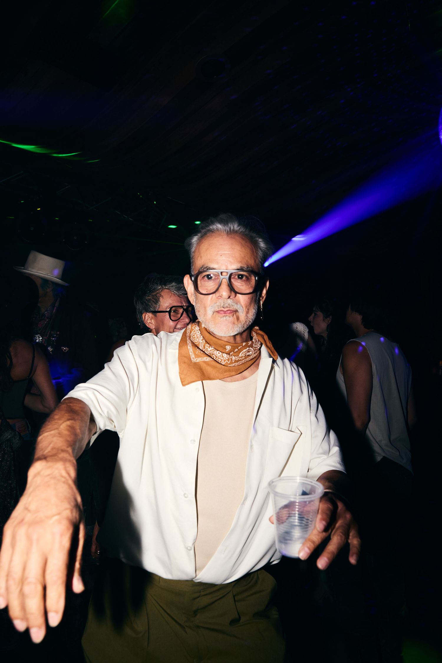 A nightclub scene shows a series of frames capturing dancing in white under colorful club lights.