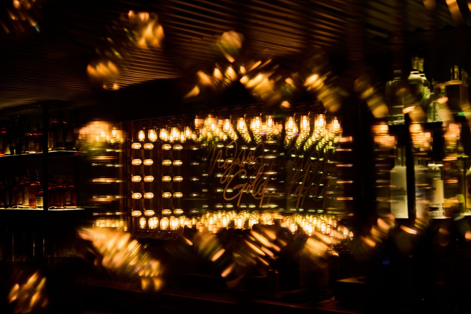 Abstract pattern of warm glowing lights creating a bokeh effect in darkness.