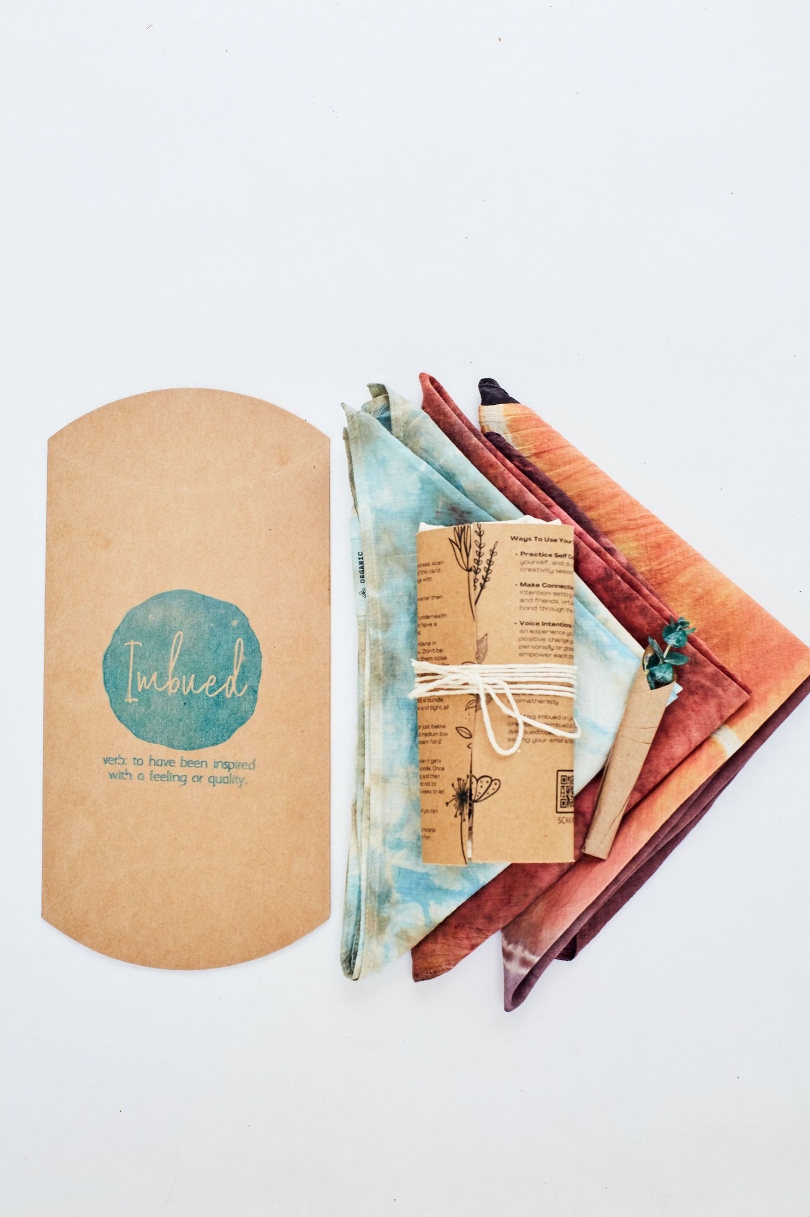 Artisanal packaging with teal logo and colorful fabric swatches.