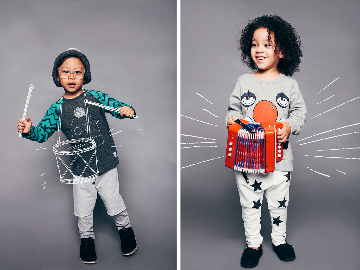 Two children wearing trendy streetwear outfits with graphic print designs pose against a gray backdrop.