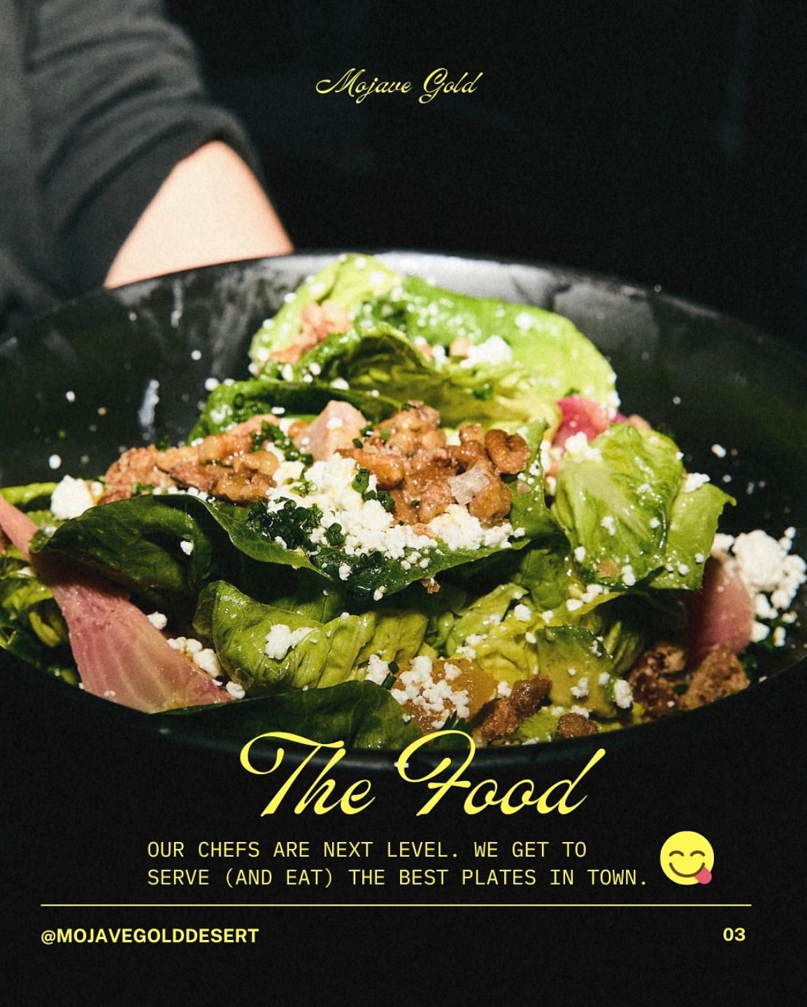 Fresh salad with crumbled feta cheese and mixed greens served on dark plates with elegant restaurant presentation.