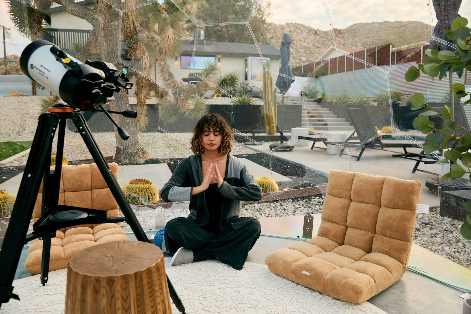 Professional photo shoot setup with lighting equipment and tan reclining chair in modern interior space.
