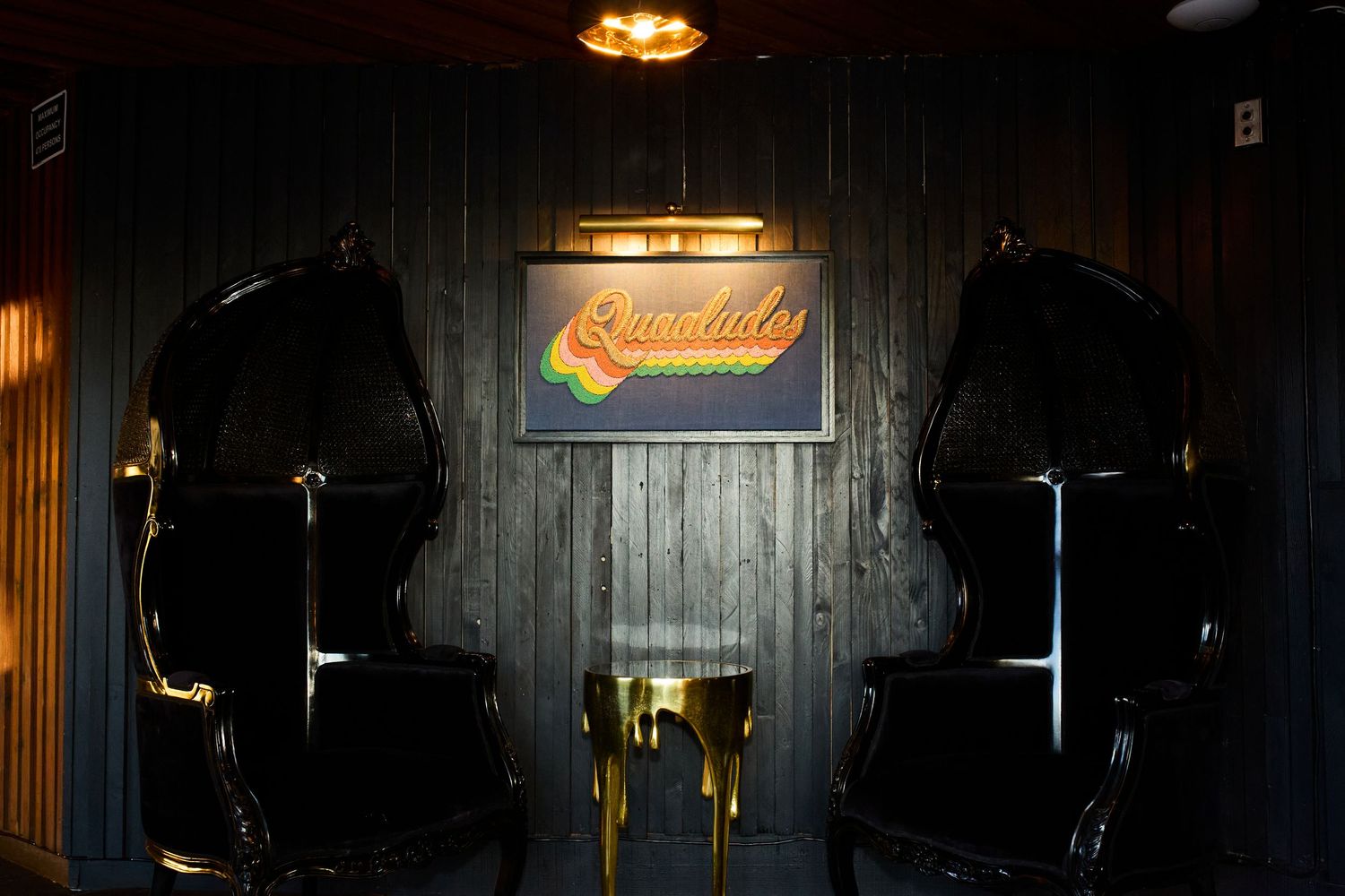A dimly lit traditional pub interior with wooden decor and illuminated beer taps along the counter.