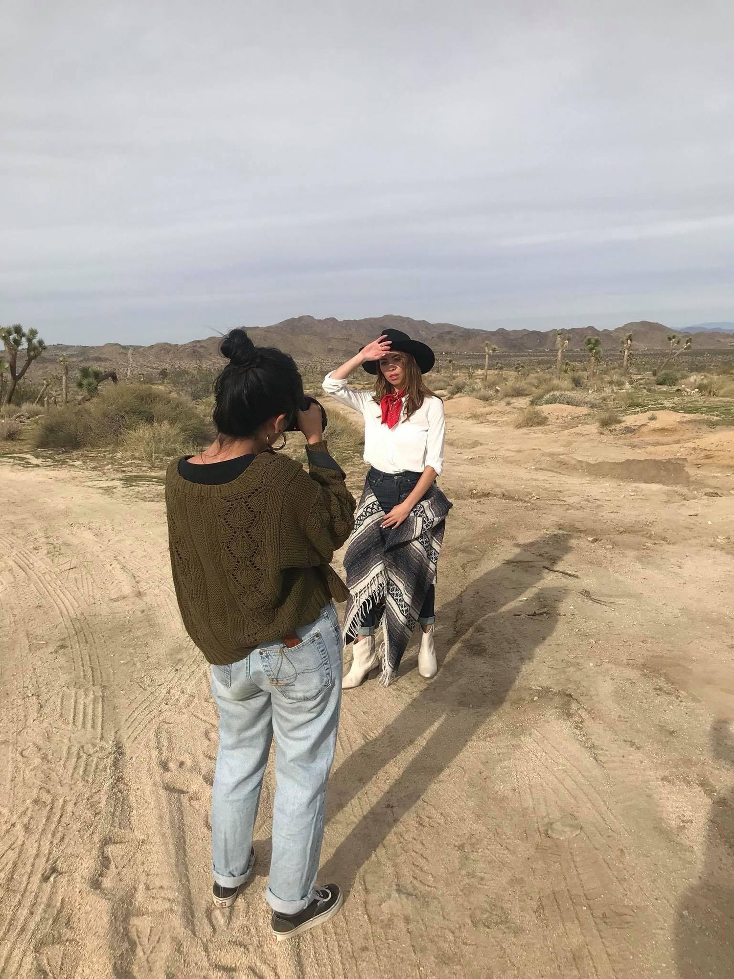 Four sequential desert landscape shots showing people practicing target shooting with firearms in an open sandy terrain.