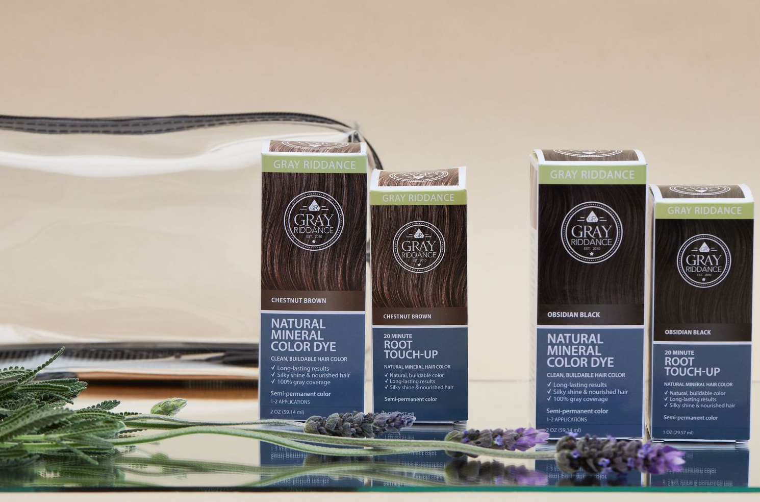 Gray Riddance hair care product line displayed with lavender sprigs against neutral background.