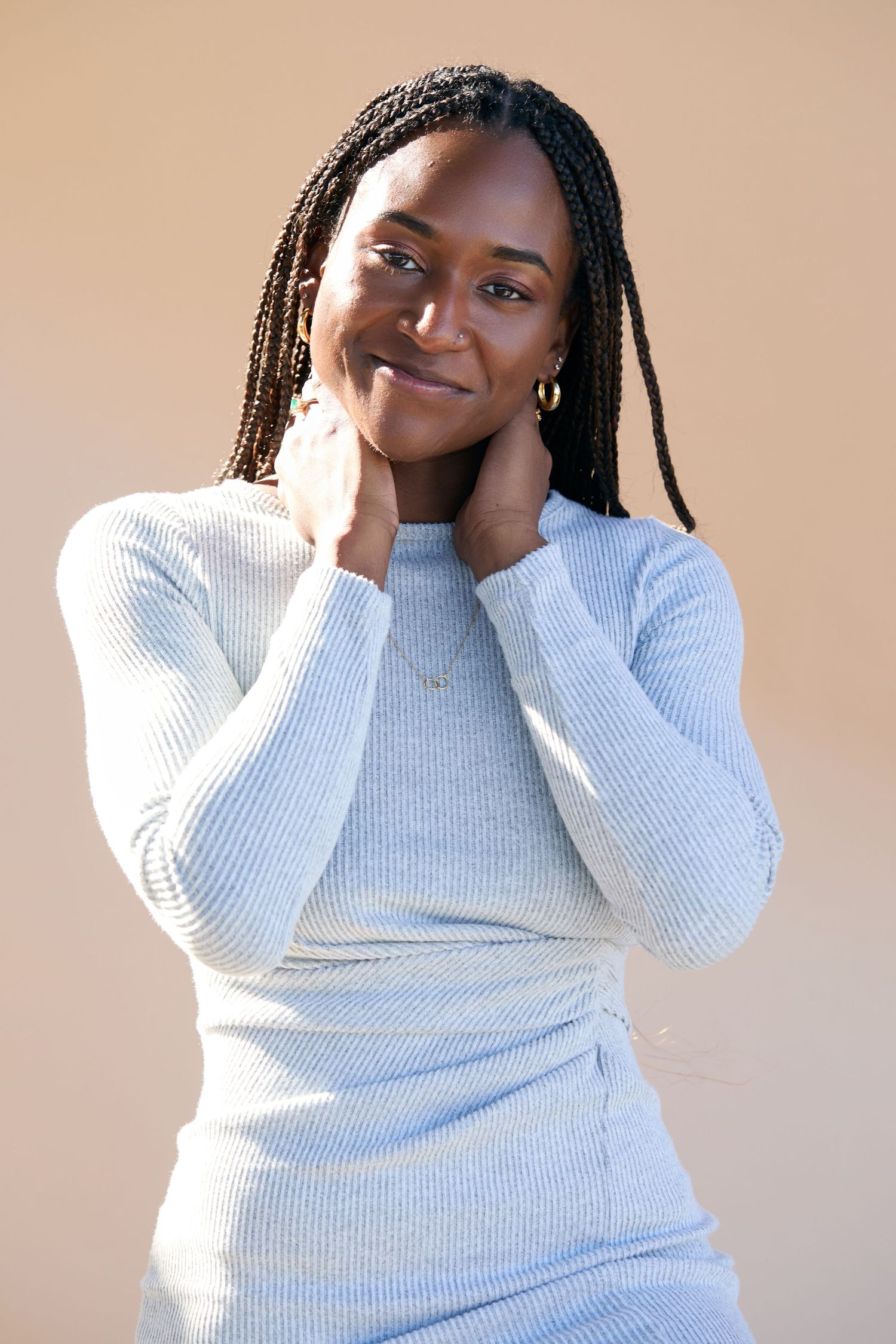 Casual portrait series in comfortable white knit sweater showing relaxed poses.