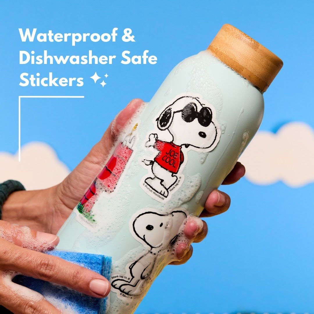 A water bottle decorated with Snoopy stickers shown against a blue background with cloud designs.
