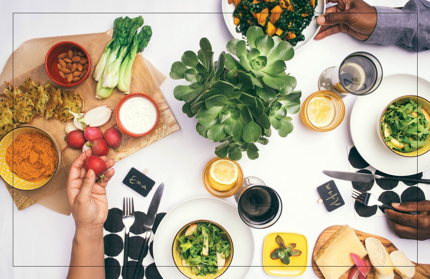 Overhead view of a table with fresh vegetables, chopped ingredients, and bowls during meal preparation in progress.