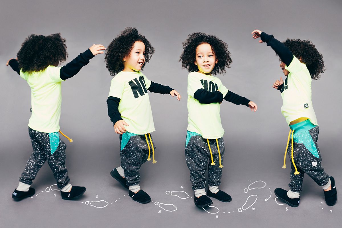 Dancing child in cream sweater and printed pants shown in four dynamic poses against gray background.