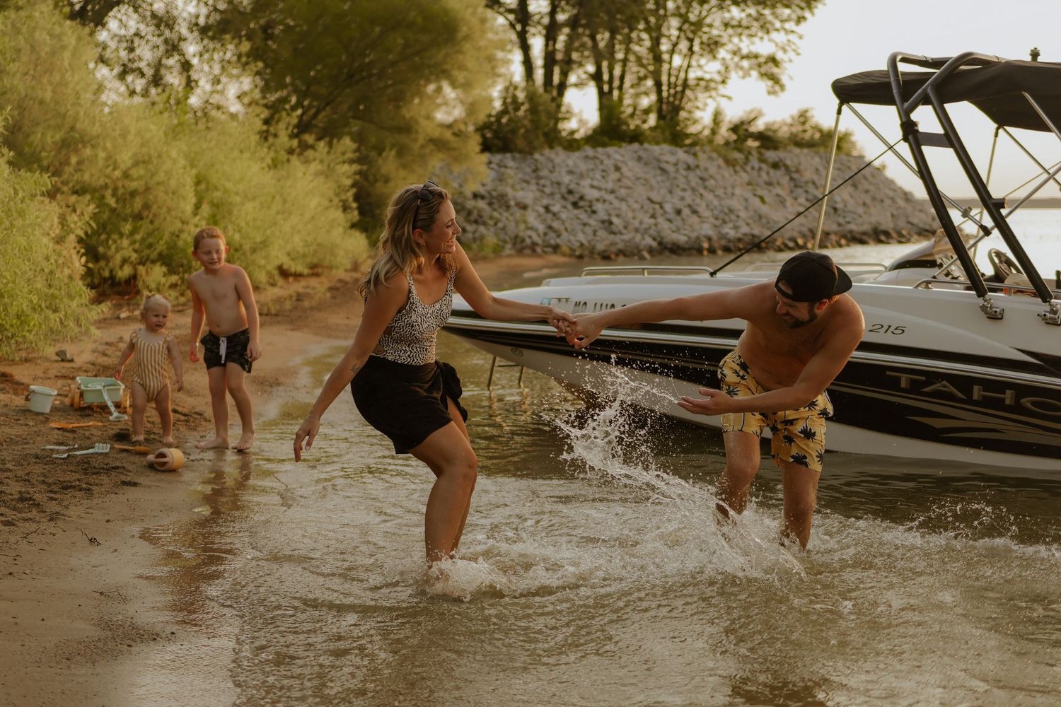 People splashing and playing in Smithville lake or swimming hole on a summer day.