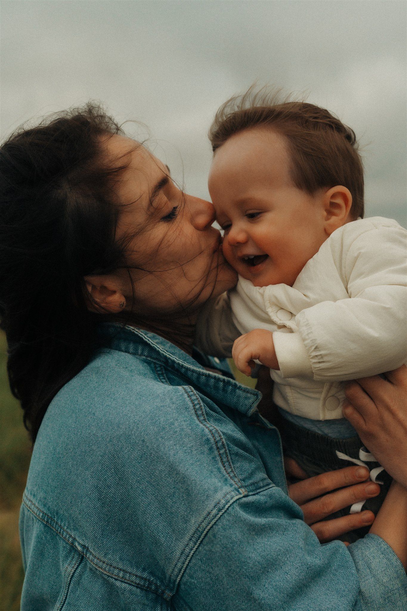 Heartwarming family photoshoot with toddler in a natural outdoor setting, capturing joyful moments and genuine connections.