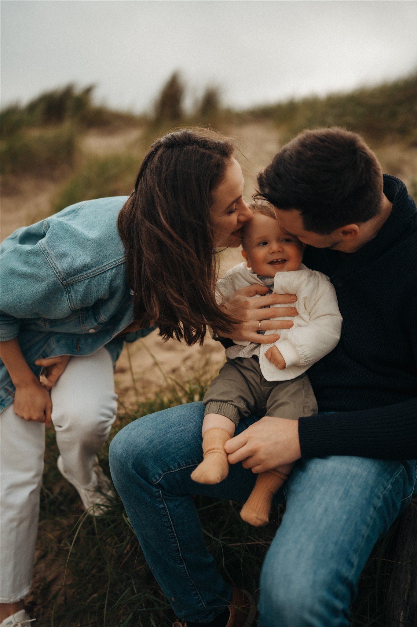 Heartwarming family photoshoot with toddler in a natural outdoor setting, capturing joyful moments and genuine connections.