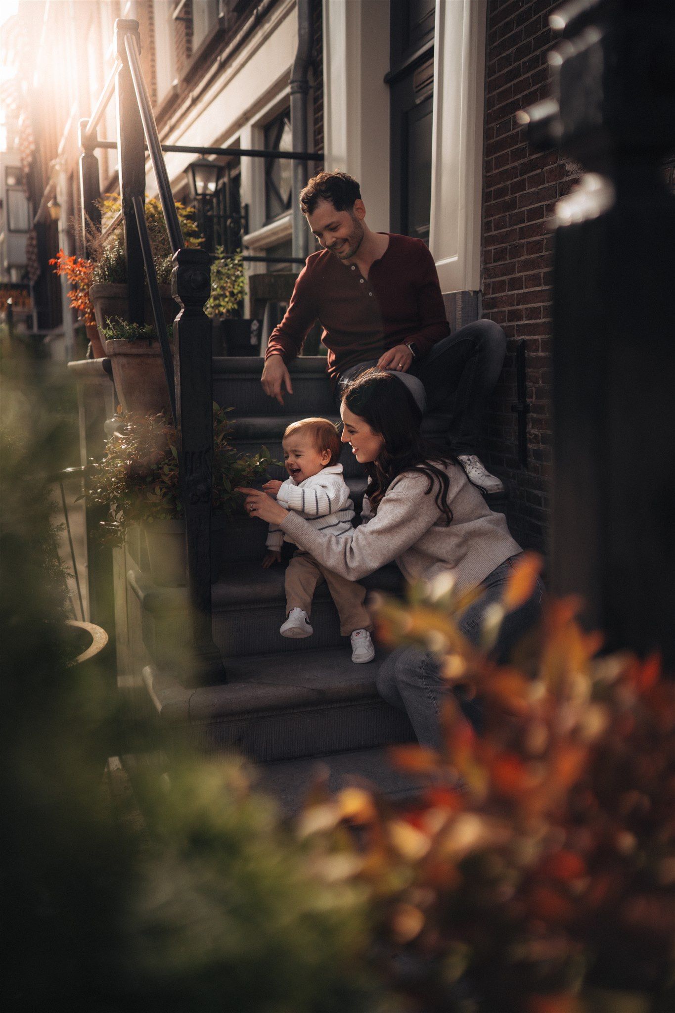 Heartwarming family photoshoot with toddler in a natural outdoor setting, capturing joyful moments and genuine connections.