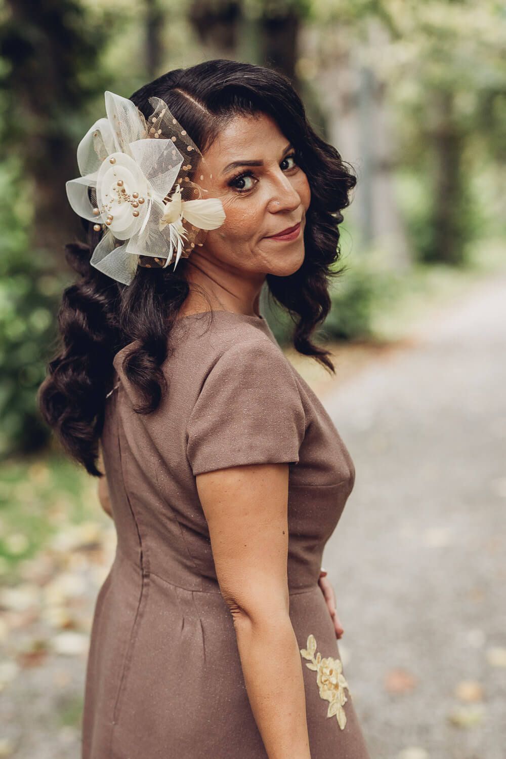 Elegantes Portrait einer Frau mit stilvollem Haarschmuck in natürlicher Gartenkulisse, fotografiert von einer Fotografin in Hannover