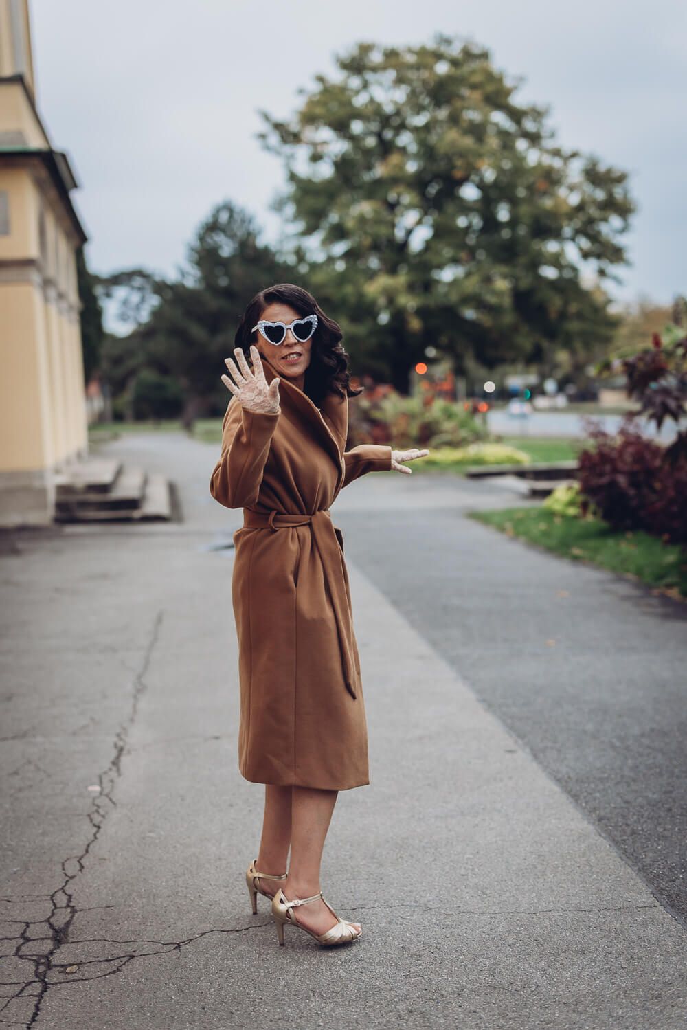 Verspieltes Ganzkörperportrait mit auffälliger Herzsonnenbrille und selbstbewusster Pose, fotografiert von einem Fotografen in Hannover
