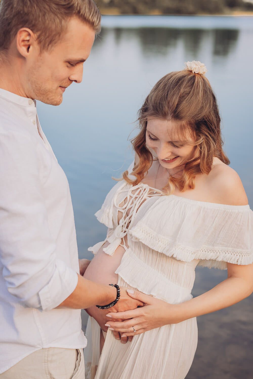 Detailaufnahme beim Babybauch Fotoshooting in Peine – Hände des Paares liegen sanft auf dem Bauch