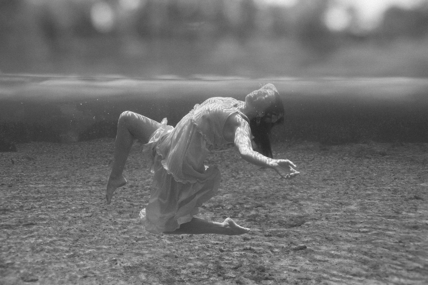 A vintage black and white photograph shows a baseball player diving to make a catch on the field.