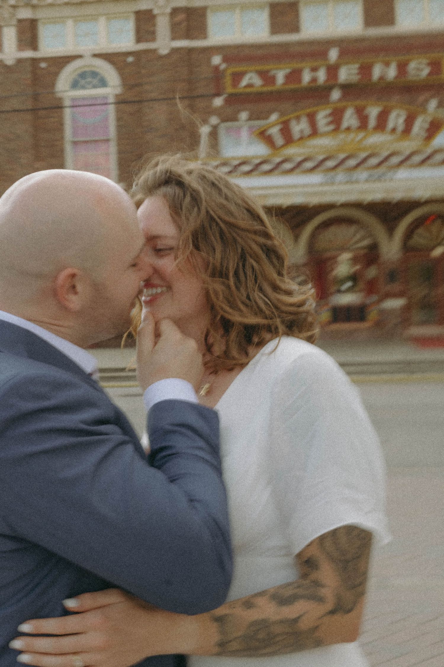 A couple in formal attire share a romantic kiss in a sequence of candid wedding photos.