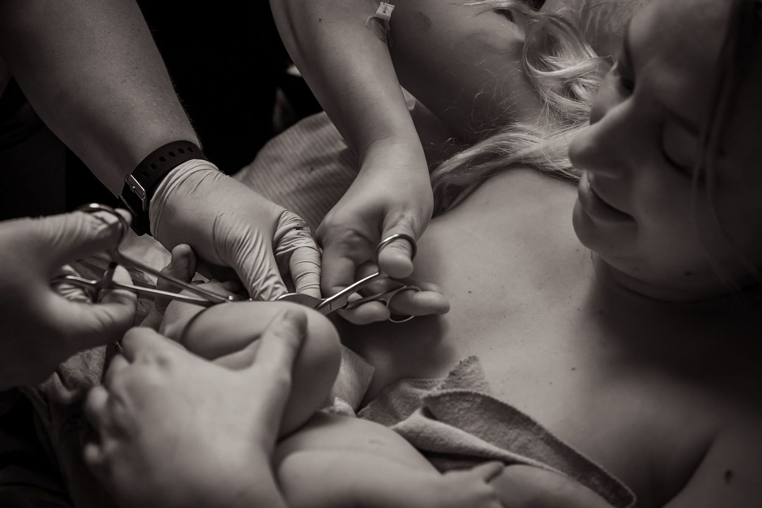 A photographer in Denver, Colorado documents the moment a mother cuts the cord of her newborn baby moments after birth.