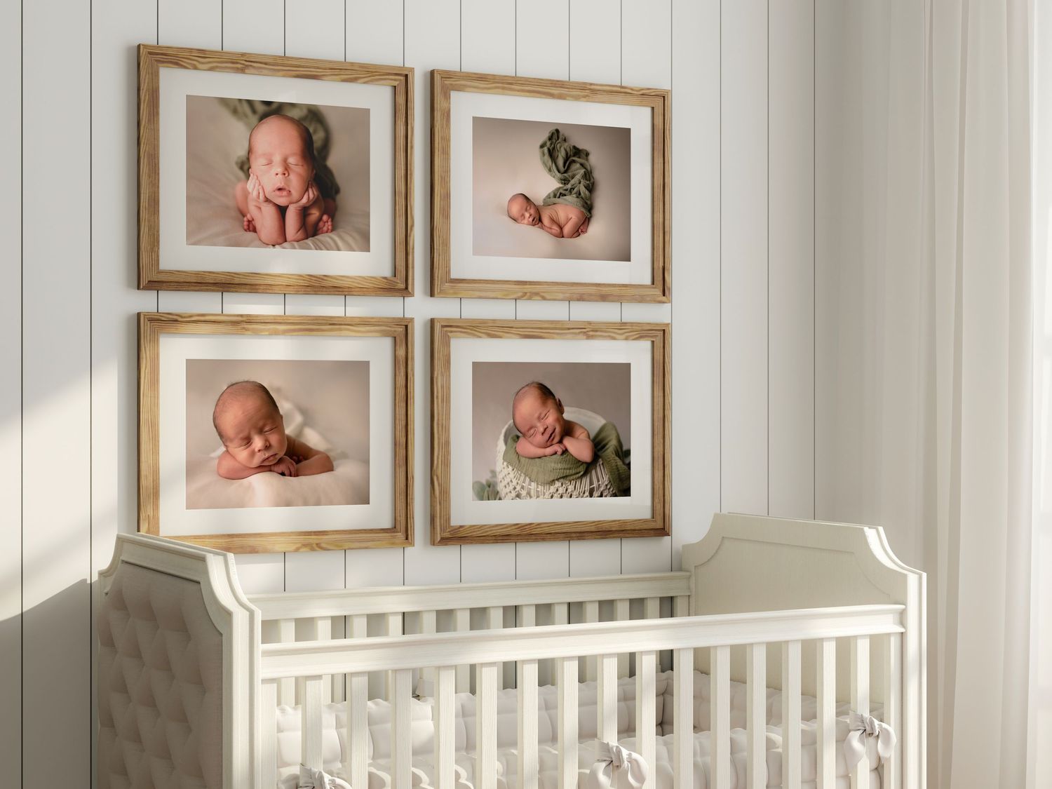 A nursery room with framed baby photos on white walls above a white crib in natural lighting.