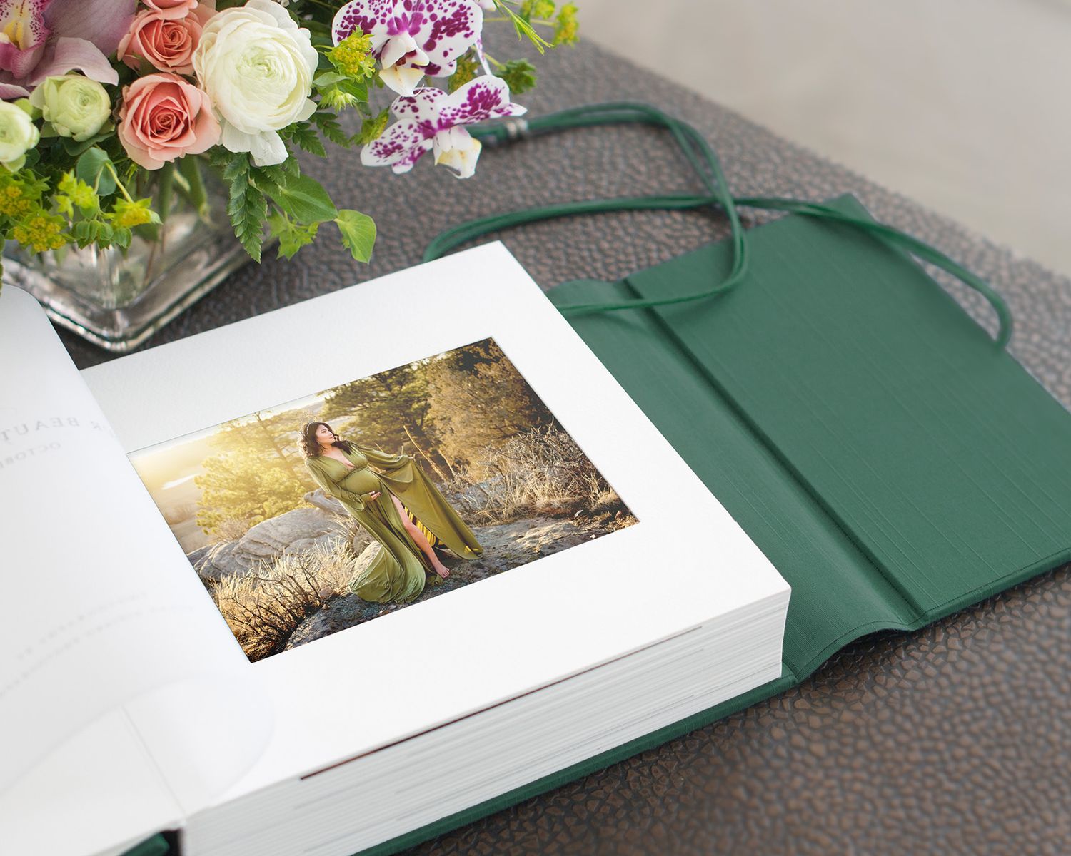 A white presentation box with floral arrangements and decorative elements displayed on a gray surface.