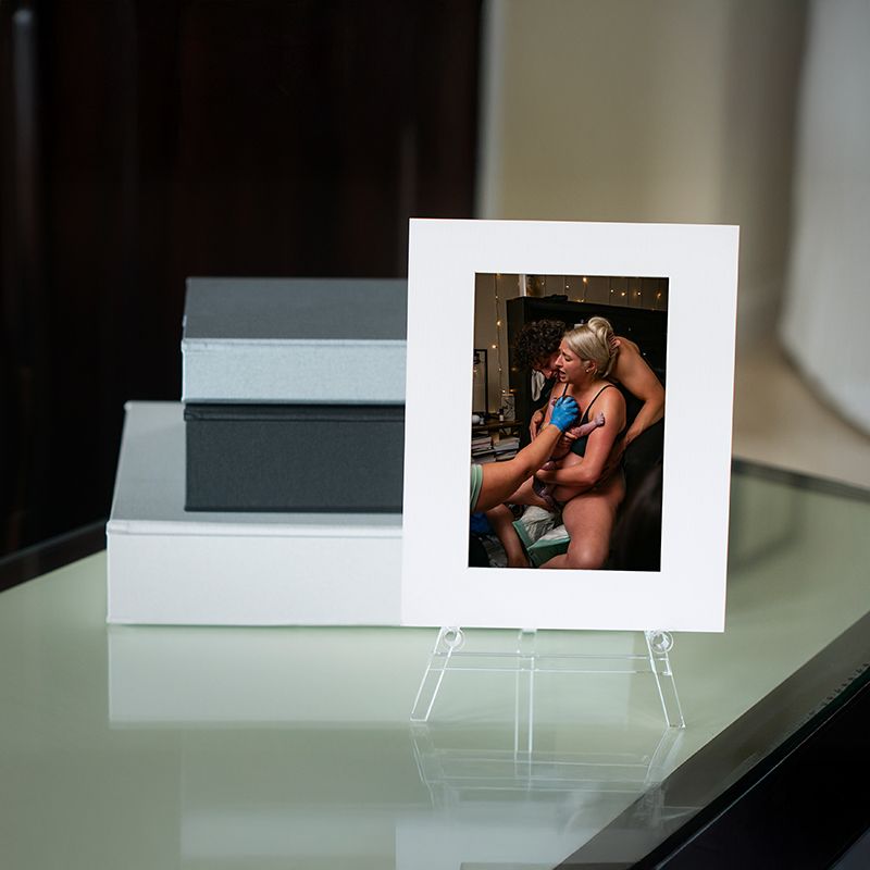 Series of polaroid photographs arranged in a minimalist sequence on a white surface showing progressive movement.