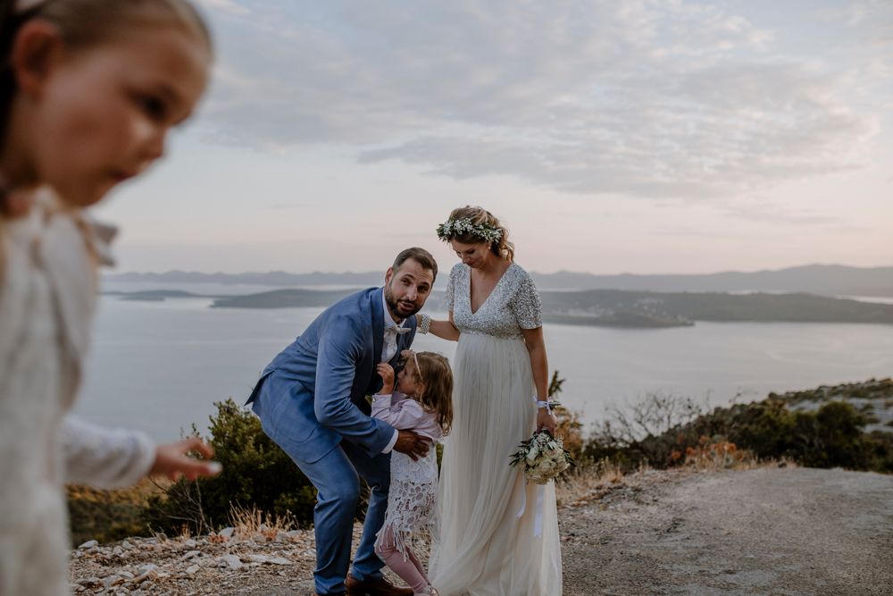 Wedding moment captured at sunset overlooking a scenic coastal landscape.