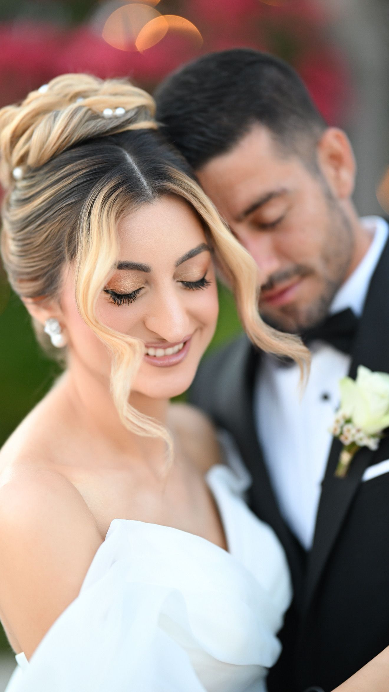 Close-up candid shots of newlyweds in formal wedding attire sharing intimate moments together outdoors.