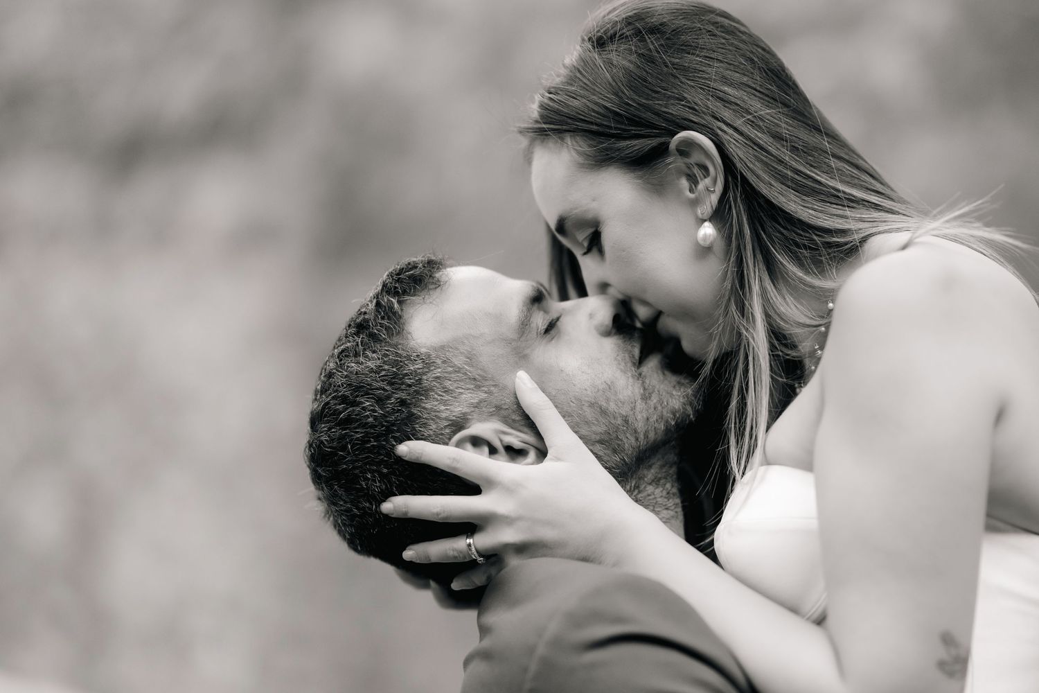 Intimate black and white portrait of wedding couple sharing a romantic moment.