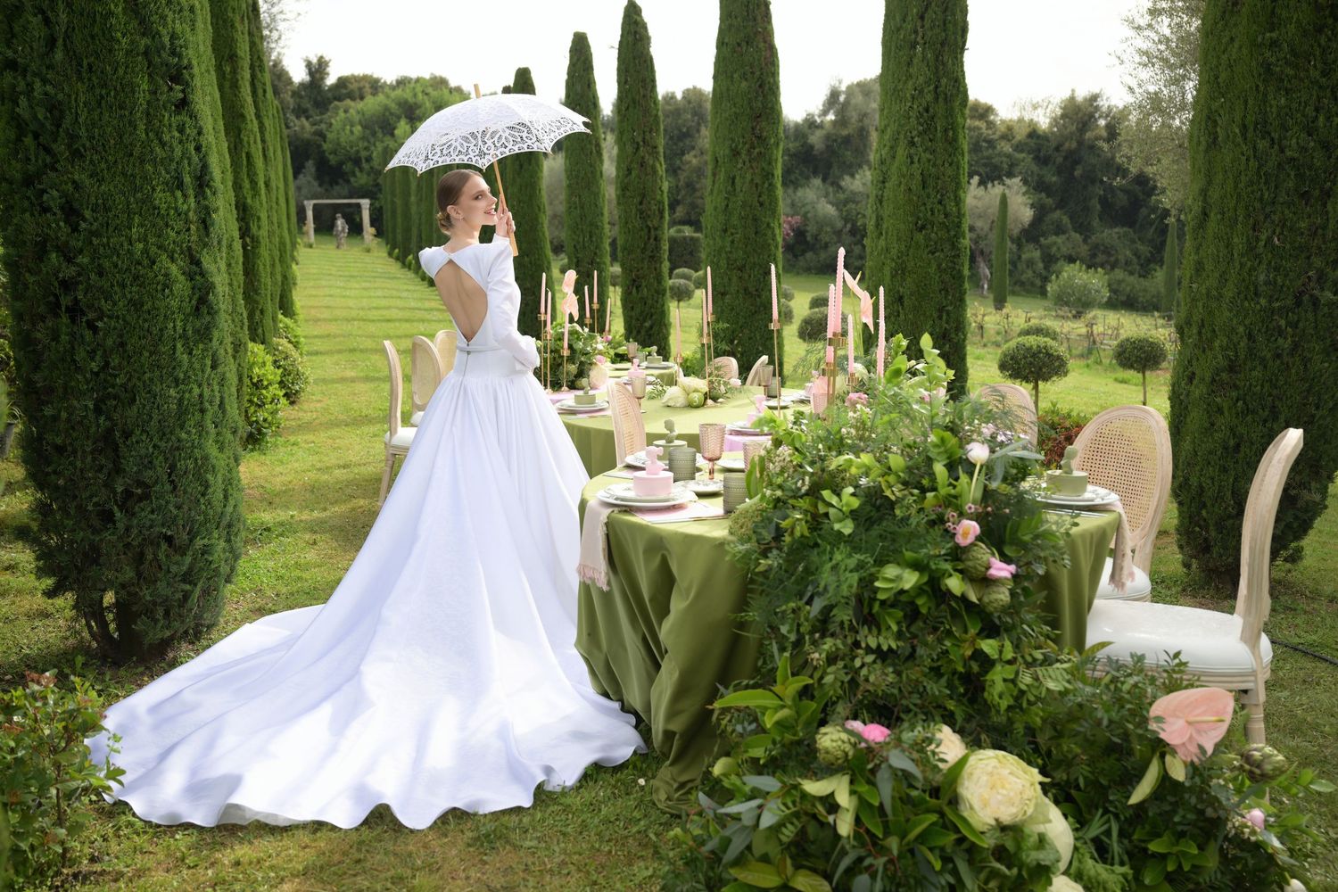 A series of elegant garden wedding photos featuring cypress trees and white decor in a lush outdoor setting.