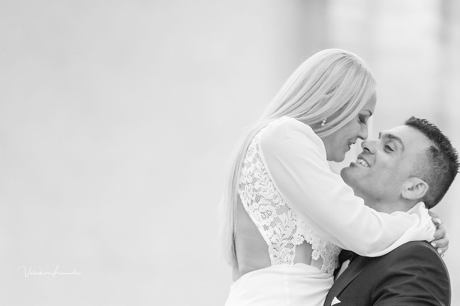 Black and white romantic wedding portrait showing intimate moment between newlyweds.