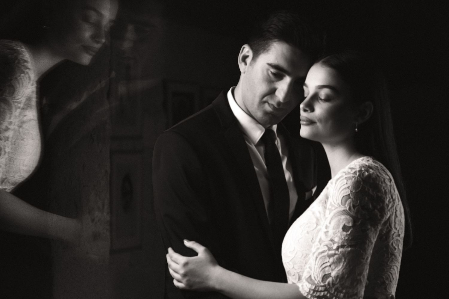 A romantic black and white wedding photo sequence showing tender moments between a couple in vintage-inspired formal attire.